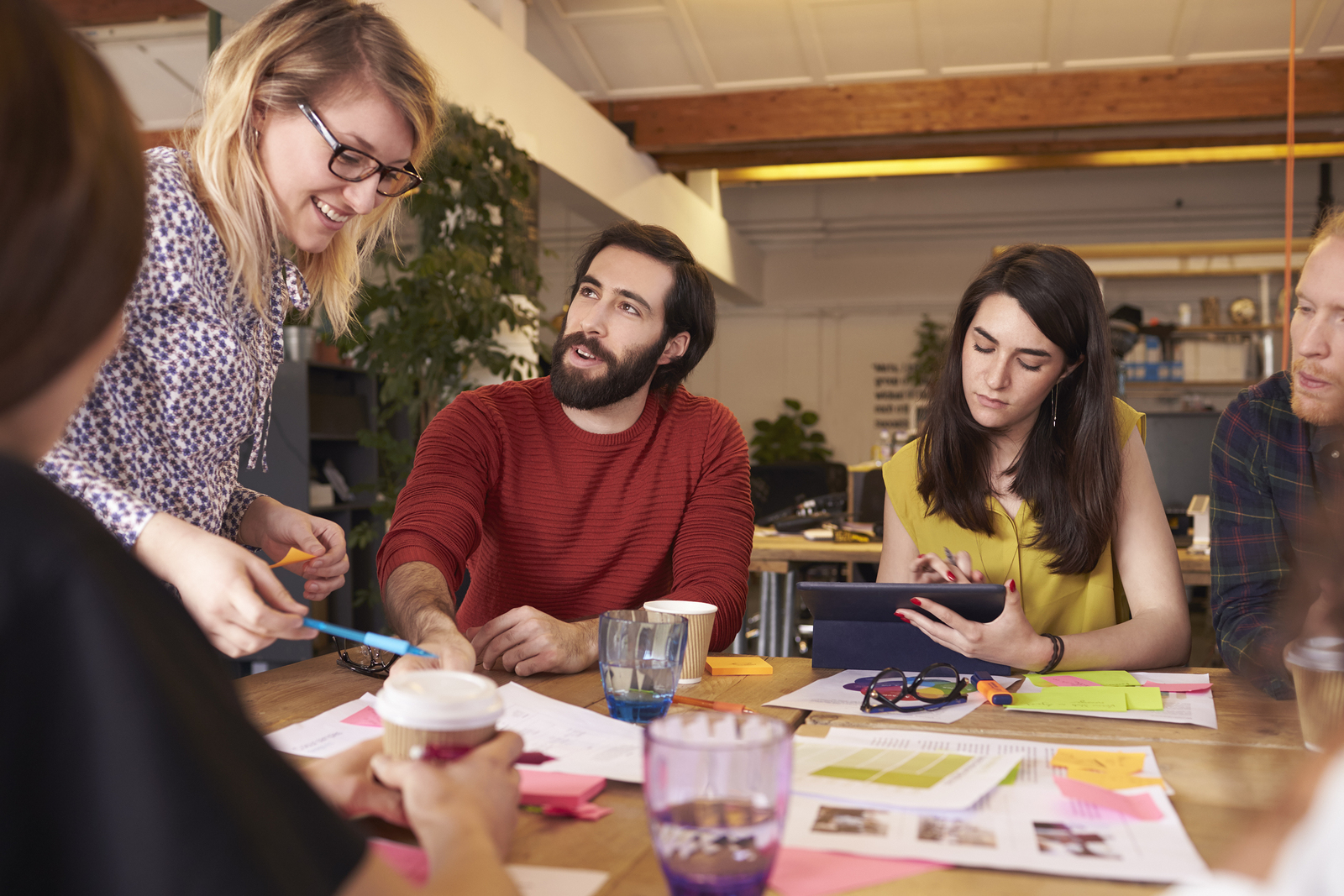 Millennial Female Manager Leads Brainstorming Meeting In Design Office